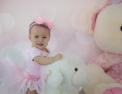 Shallow focal baby wearing a pink dress in the photo
